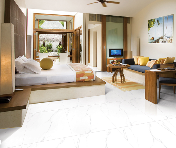 H&igrave;nh ảnh ph&ograve;ng ngủ được phối m&agrave;u gạch l&aacute;t với sơn tường trắng s&aacute;ng, đối diện giường l&agrave; bộ ghế sofa l&agrave;m nơi đọc s&aacute;ch, thư gi&atilde;n