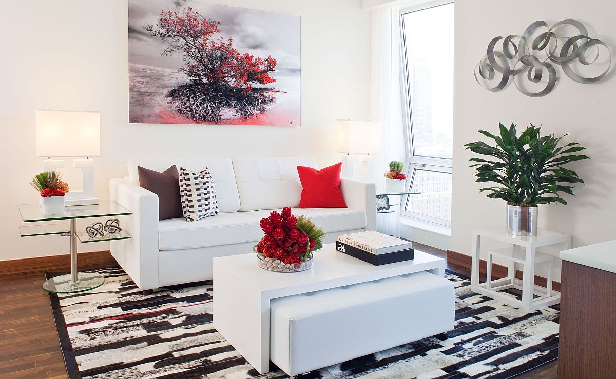 To&agrave;n cảnh ph&ograve;ng kh&aacute;ch nhỏ m&agrave;u trắng được nhấn nh&aacute; bởi gối tựa sofa, tranh treo tường m&agrave;u đỏ ấn tượng