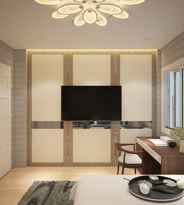 Hình ảnh một góc phòng ngủ với tivi treo tường, bàn làm việc cạnh giường