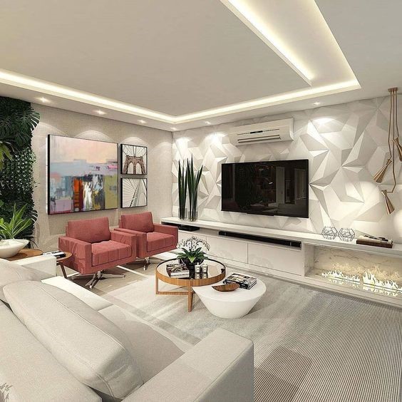 H&igrave;nh ảnh ph&ograve;ng kh&aacute;ch nh&agrave; ống với đ&egrave;n LED &acirc;m trần, sofa x&aacute;m, hai ghế b&agrave;nh m&agrave;u hồng, b&agrave;n tr&agrave; tr&ograve;n, c&acirc;y xanh tạo điểm nhấn