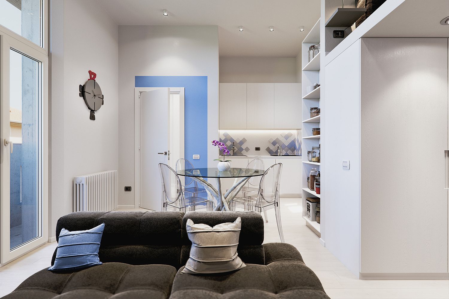 H&igrave;nh ảnh một g&oacute;c ph&ograve;ng kh&aacute;ch với sofa x&aacute;m đen, gối tựa m&agrave;u xanh da trời v&agrave; be, cạnh đ&oacute; l&agrave; bếp ăn