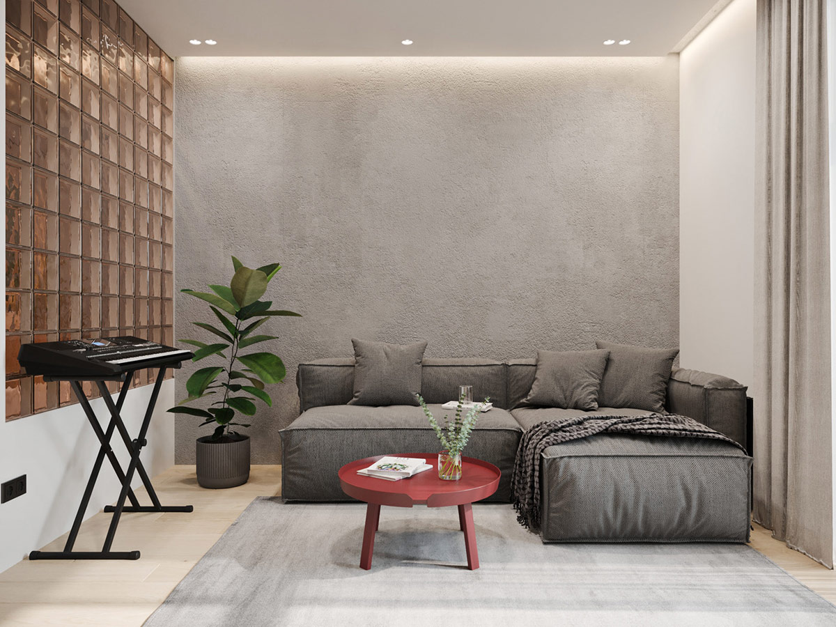 h&igrave;nh ảnh ph&ograve;ng kh&aacute;ch căn hộ nhỏ dưới 50m2 với tường b&ecirc; t&ocirc;ng x&aacute;m c&ugrave;ng t&ocirc;ng với ghế sofa chữ L v&agrave; thảm trải s&agrave;n