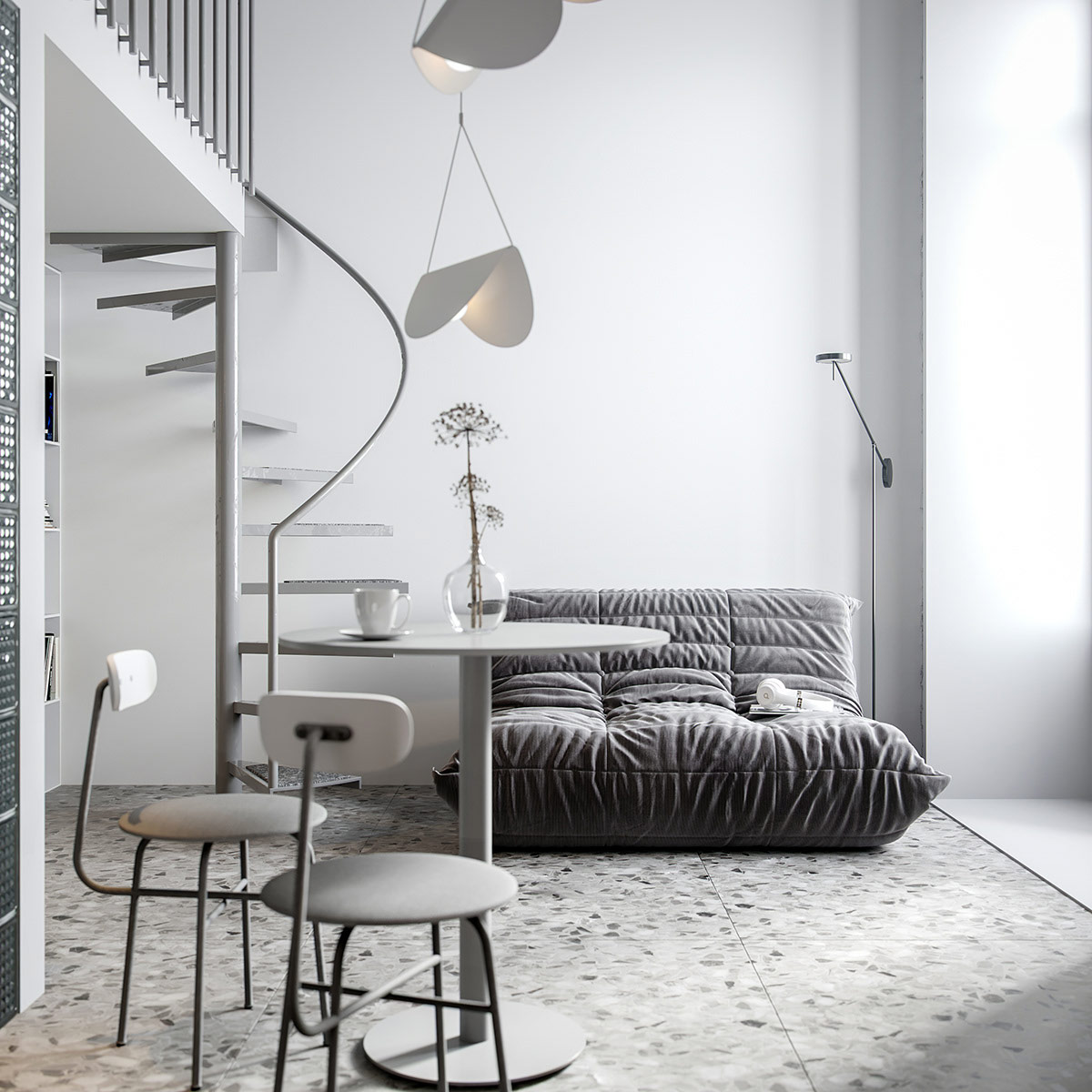 hình ảnh tầng trệt căn hộ 25,6m2 với ghế sofa giường màu xám, bàn ăn tròn nhỏ, cầu thang xoắn ốc lên tầng lửng