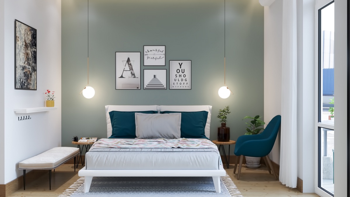 h&igrave;nh ảnh ph&ograve;ng ngủ nhỏ tho&aacute;ng s&aacute;ng với tường đầu giường sơn m&agrave;u xanh l&aacute;, bộ tranh treo tường, đ&egrave;n thả đối xứng, ghế thư gi&atilde;n m&agrave;u xanh dương