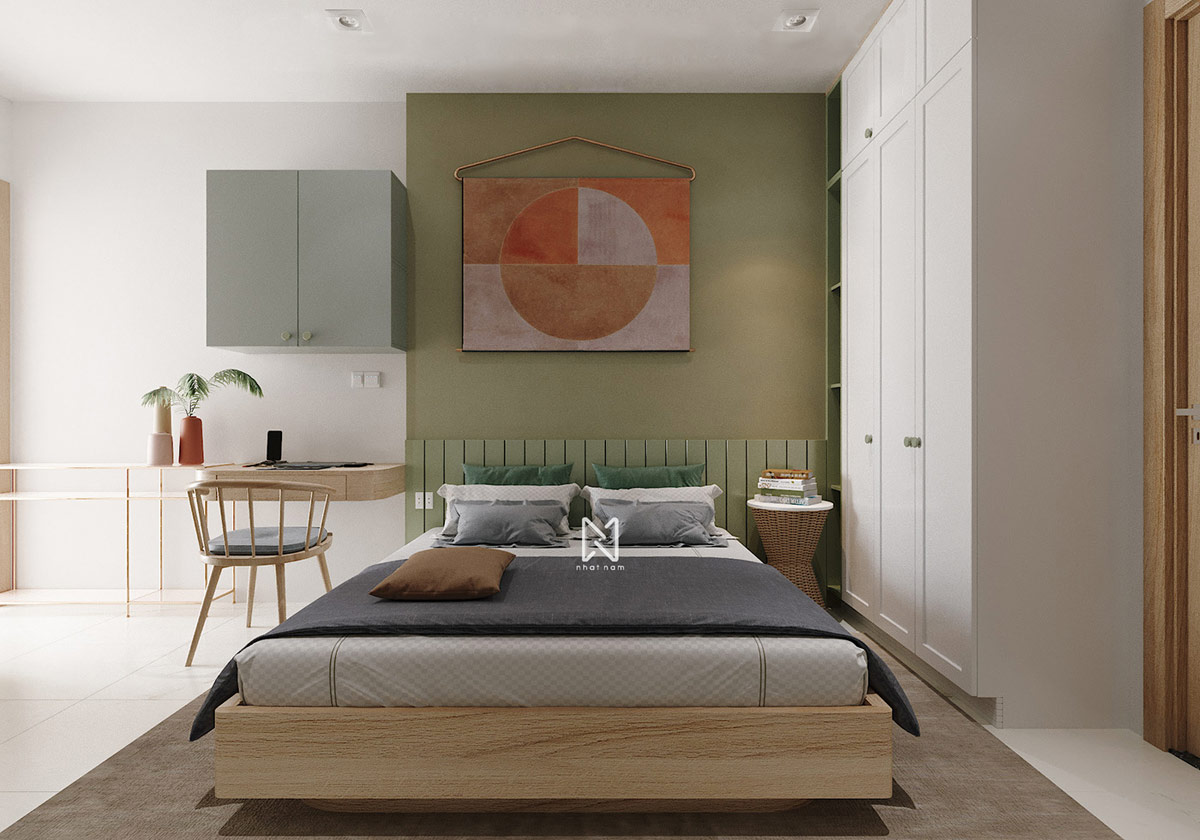 h&igrave;nh ảnh to&agrave;n cảnh ph&ograve;ng ngủ trong căn hộ 66m2 với giường đ&ocirc;i, tường đầu giường sơn xanh, tranh tường m&agrave;u cam đất, b&agrave;n l&agrave;m việc gắn tường, tủ tường, tủ quần &aacute;o m&agrave;u trắng