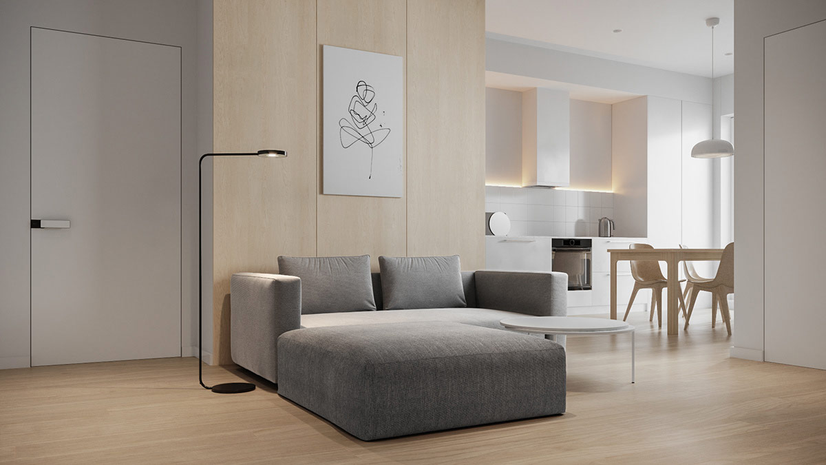 hình ảnh phòng khách căn hộ phong cách tối giản với ghế sofa màu xám trung tính, bàn trà tròn cùng tông màu, tranh treo tường màu trắng đen tinh tế