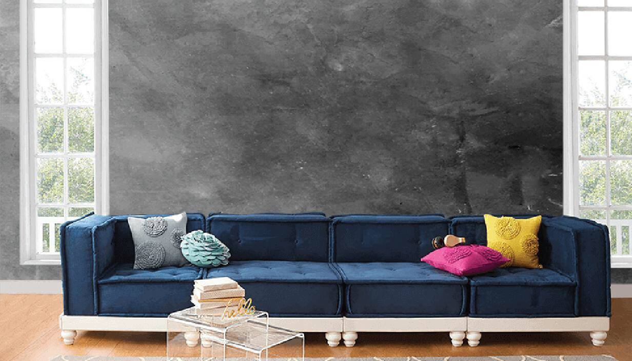 Ghế sofa m&agrave;u xanh dương, gối tựa m&agrave;u sắc rực rỡ nổi bật tr&ecirc;n nền tường b&ecirc; t&ocirc;ng x&aacute;m.