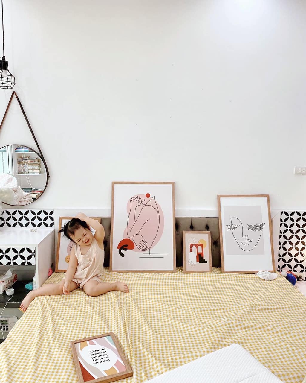 Bé gái ngồi trên giường