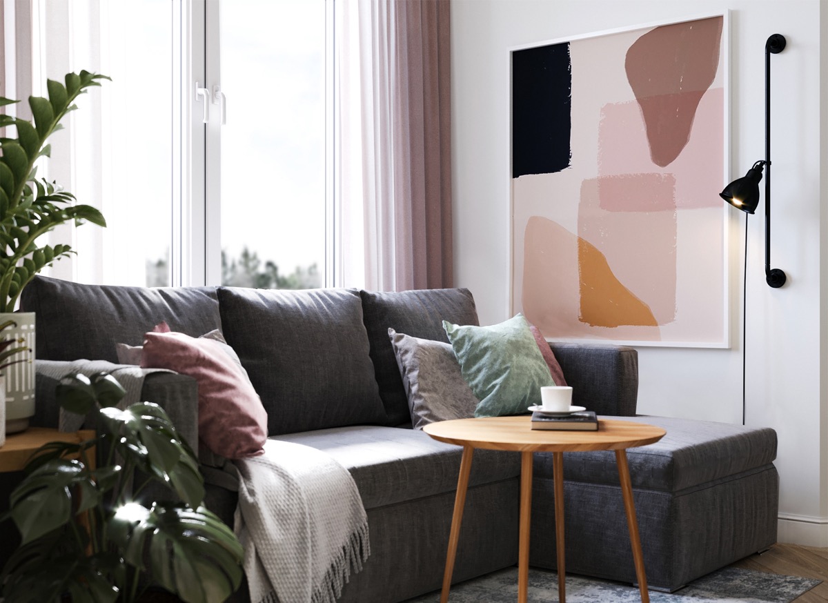 Ph&ograve;ng kh&aacute;ch căn hộ nhỏ được đ&oacute;ng khung bởi bộ ghế sofa m&agrave;u x&aacute;m sang trọng, b&agrave;n tr&agrave; gỗ ch&acirc;n cao tho&aacute;ng v&agrave; tranh nghệ thuật treo tường ấn tượng.