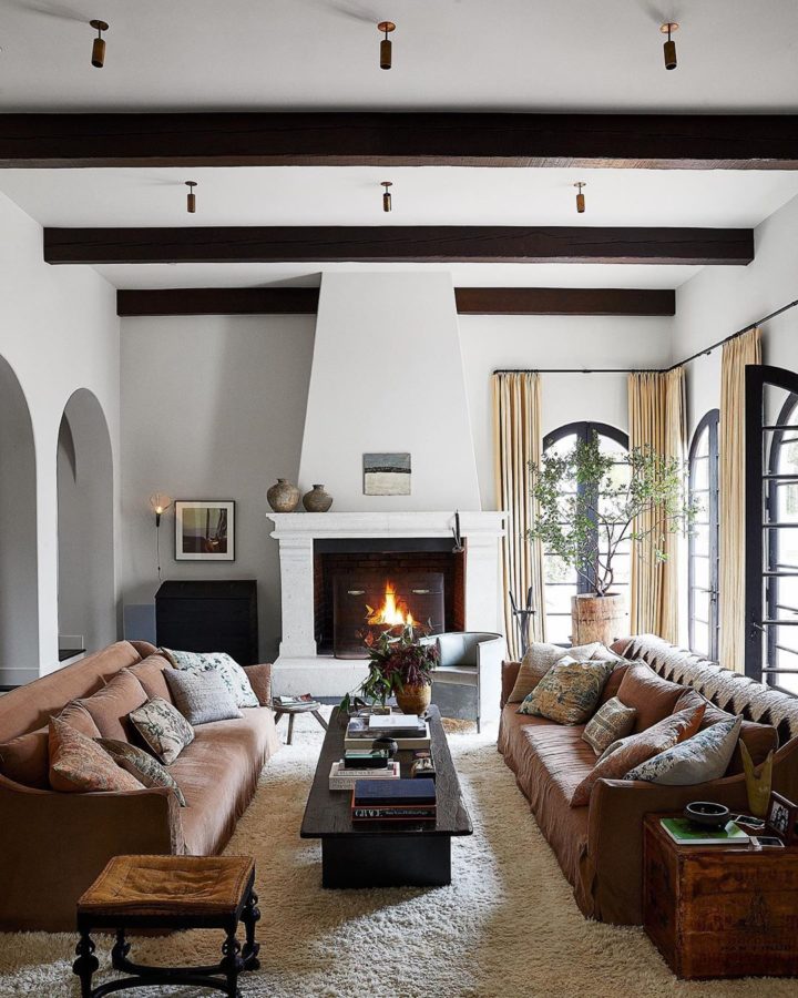 ph&ograve;ng kh&aacute;ch nhỏ với hai ghế sofa n&acirc;u đặt đối diện qua b&agrave;n tr&agrave; m&agrave;u đen