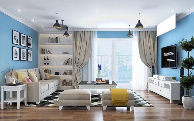h&igrave;nh ảnh ph&ograve;ng kh&aacute;ch nh&agrave; ống 4 tầng với trần m&agrave;u trắng, tường xanh dương, sofa, tranh tường, thảm trải họa tiết h&igrave;nh học