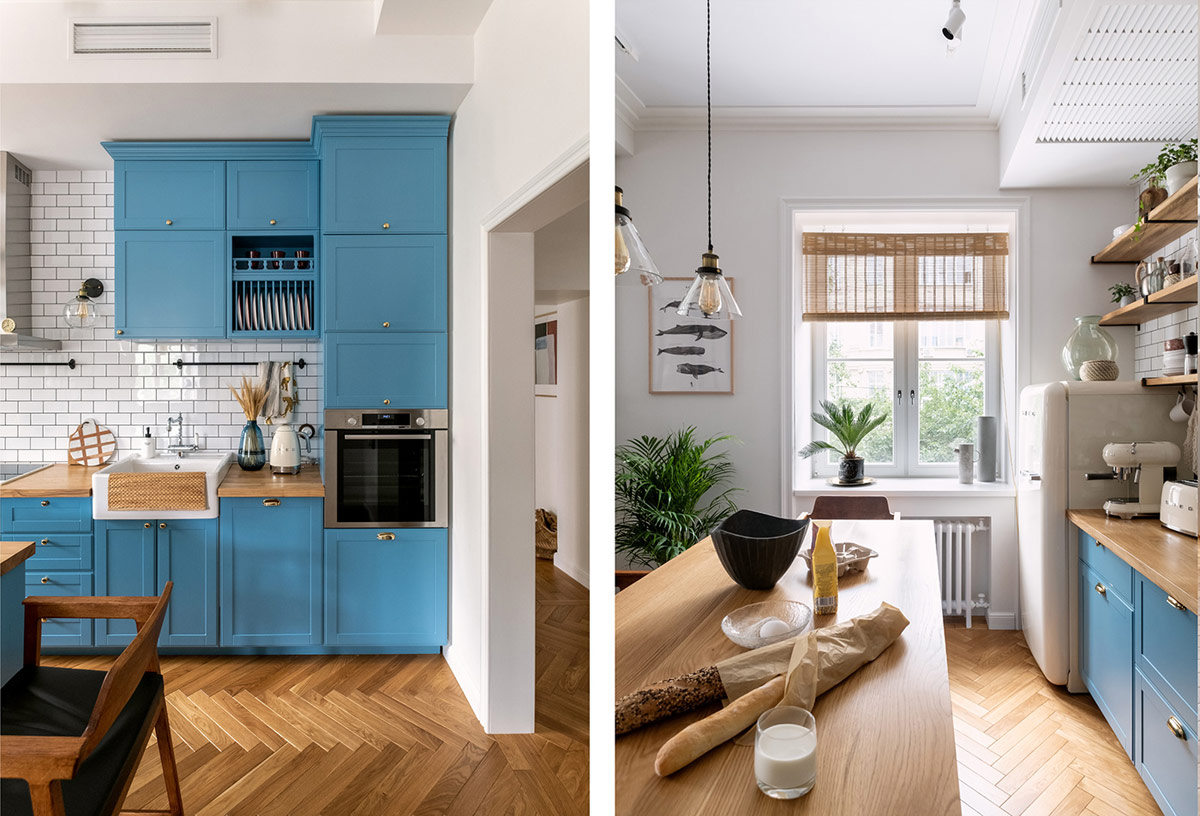 h&igrave;nh ảnh ph&ograve;ng bếp căn hộ 74m2 với tường ốp gạch trắng, tủ bếp m&agrave;u xanh lam, c&acirc;y xanh trang tr&iacute;