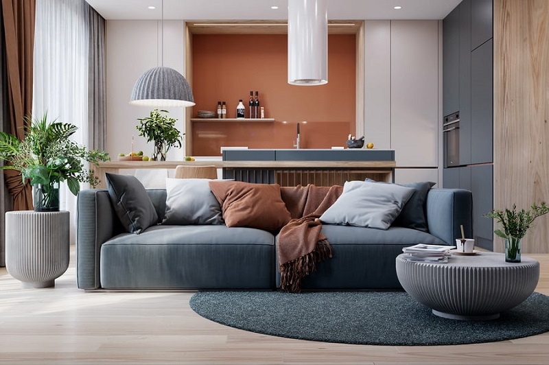 hình ảnh phòng khách đẹp với sofa màu xanh dương nhạt, bàn trà tròn lạ mắt, cây xanh trang trí