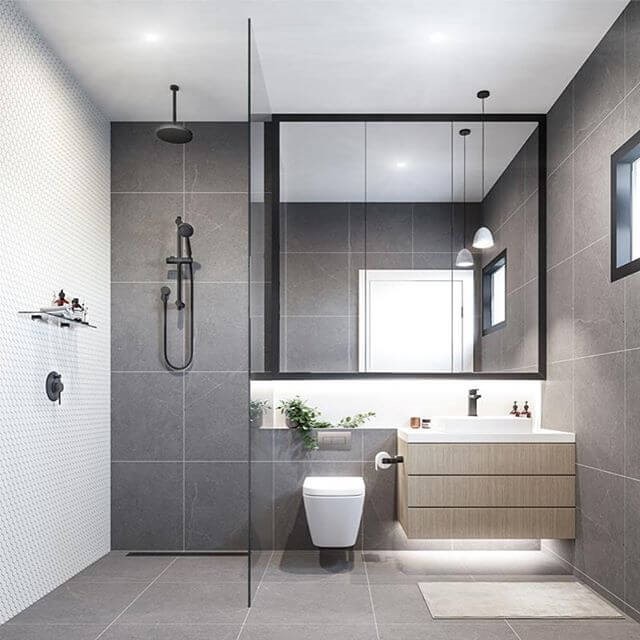 hình ảnh phòng vệ sinh trong nhà cấp 4 với tường ốp gạch màu xám, vách kính phân tách khu vệ sinh và bồn rửa bên ngoài