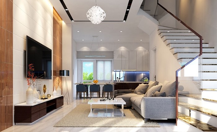 Phòng khách nhà vườn được thiết kế theo phong cách hiện đại, tối giản mà tinh tế. Lan can cầu thang bằng kính cường lực trong suốt tạo độ thoáng cho không gian nhà đẹp.
