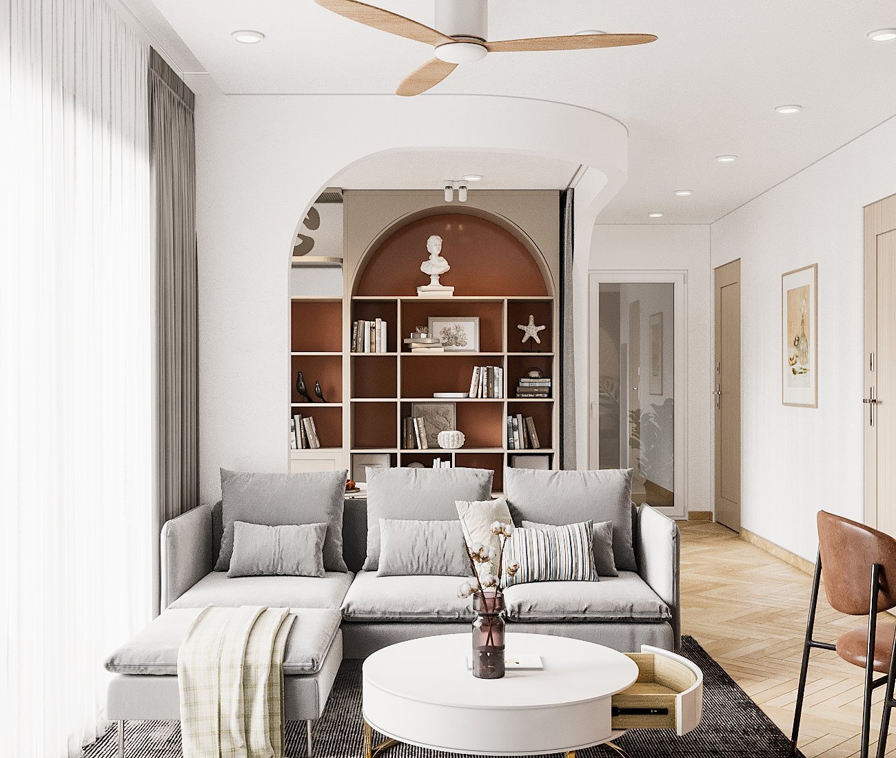 Không gian phòng khách được định vị bởi bộ ghế sofa màu xám nhạt và bàn trà tròn màu trắng tích hợp ngăn kéo đặt gọn gàng trên thảm trải sàn.