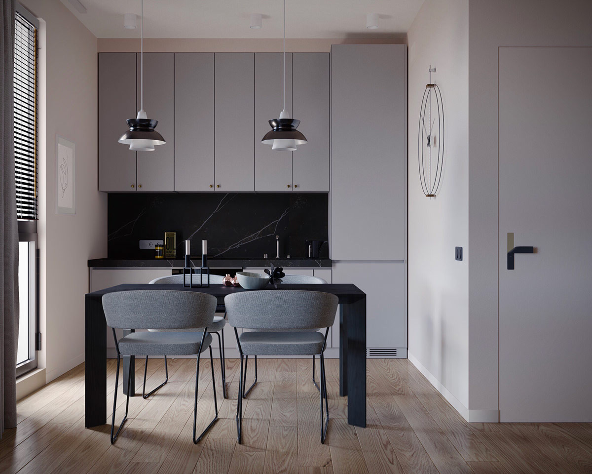 Ph&ograve;ng bếp m&agrave;u đen - x&aacute;m, sử dụng chất liệu đ&aacute; cẩm thạch sang trọng. Một chiếc đồng hồ treo tường lớn tạo điểm nhấn trang tr&iacute; tinh tế. Cặp đ&ocirc;i đ&egrave;n thả mặt d&acirc;y chuyền gi&uacute;p định vi kh&ocirc;ng gian ăn uống gọn đẹp d&agrave;nh cho 4 người.