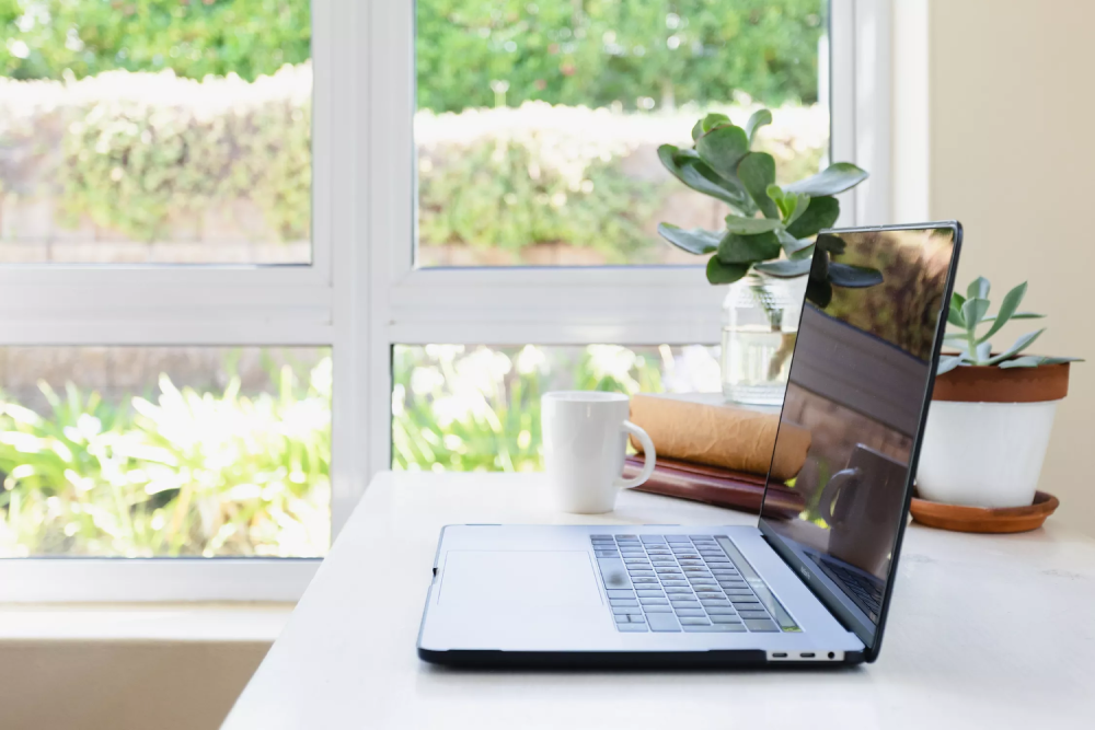 &aacute;nh s&aacute;ng tự nhi&ecirc;n trong kh&ocirc;ng gian văn ph&ograve;ng, m&aacute;y laptop để b&agrave;n, cửa sổ k&iacute;nh