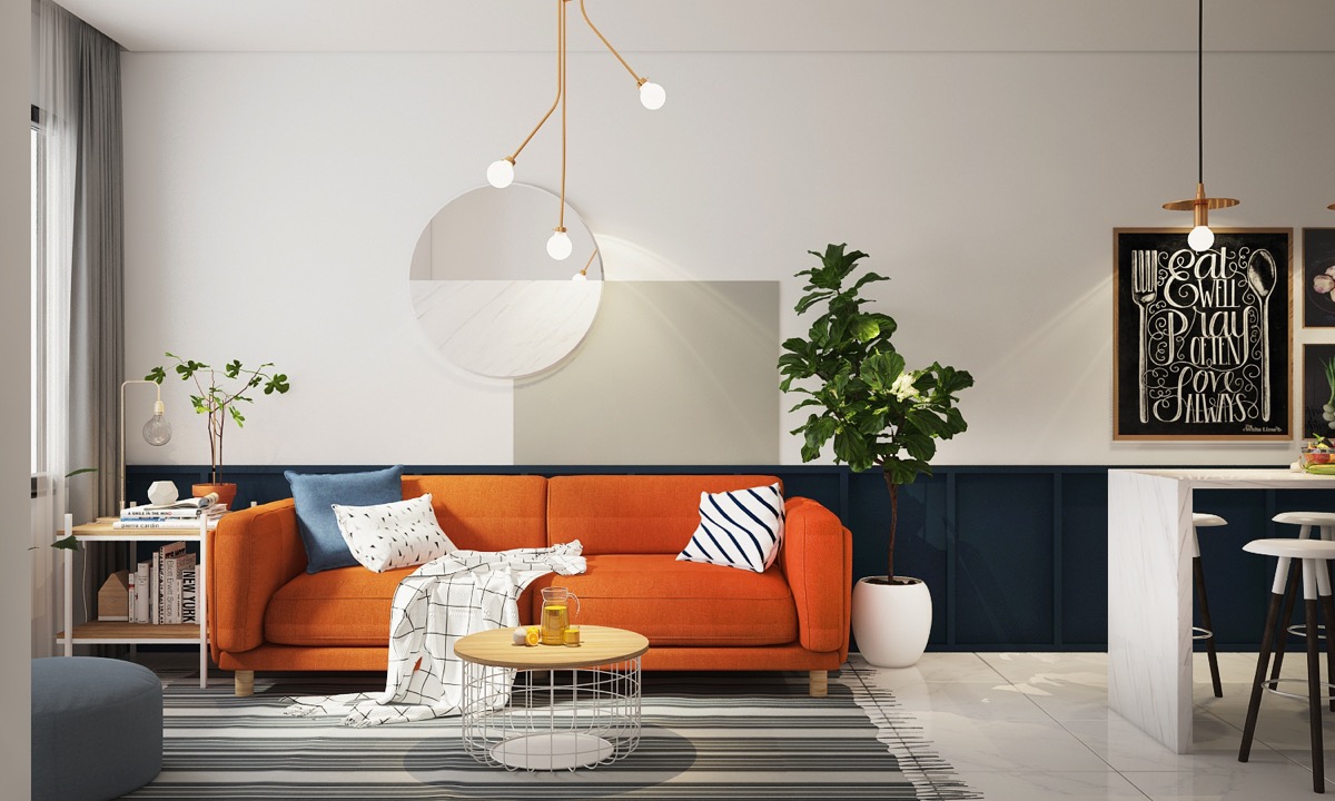 Gia chủ trang tr&iacute; ph&ograve;ng kh&aacute;ch theo phong c&aacute;ch hiện đại tối giản với điểm nhấn ấm &aacute;p l&agrave; ghế sofa m&agrave;u cam kết hợp c&ugrave;ng thảm trải kẻ sọc m&agrave;u x&aacute;m, c&acirc;y xanh đối xứng hai b&ecirc;n.