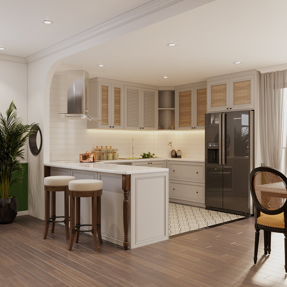 Bàn bếp chữ U được kéo dài thành quầy bar mini gọn xinh, nơi các thành viên gia đình thưởng thức bữa sáng hoặc nhâm nhi ly rượu vang, chuyện trò...