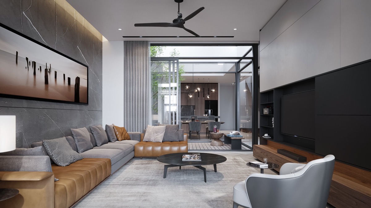 B&agrave;n c&agrave; ph&ecirc; tr&ograve;n đặt ở t&acirc;m ph&ograve;ng kh&aacute;ch tạo sự c&acirc;n bằng về h&igrave;nh khối so với tivi, sofa, khung tranh treo tường...