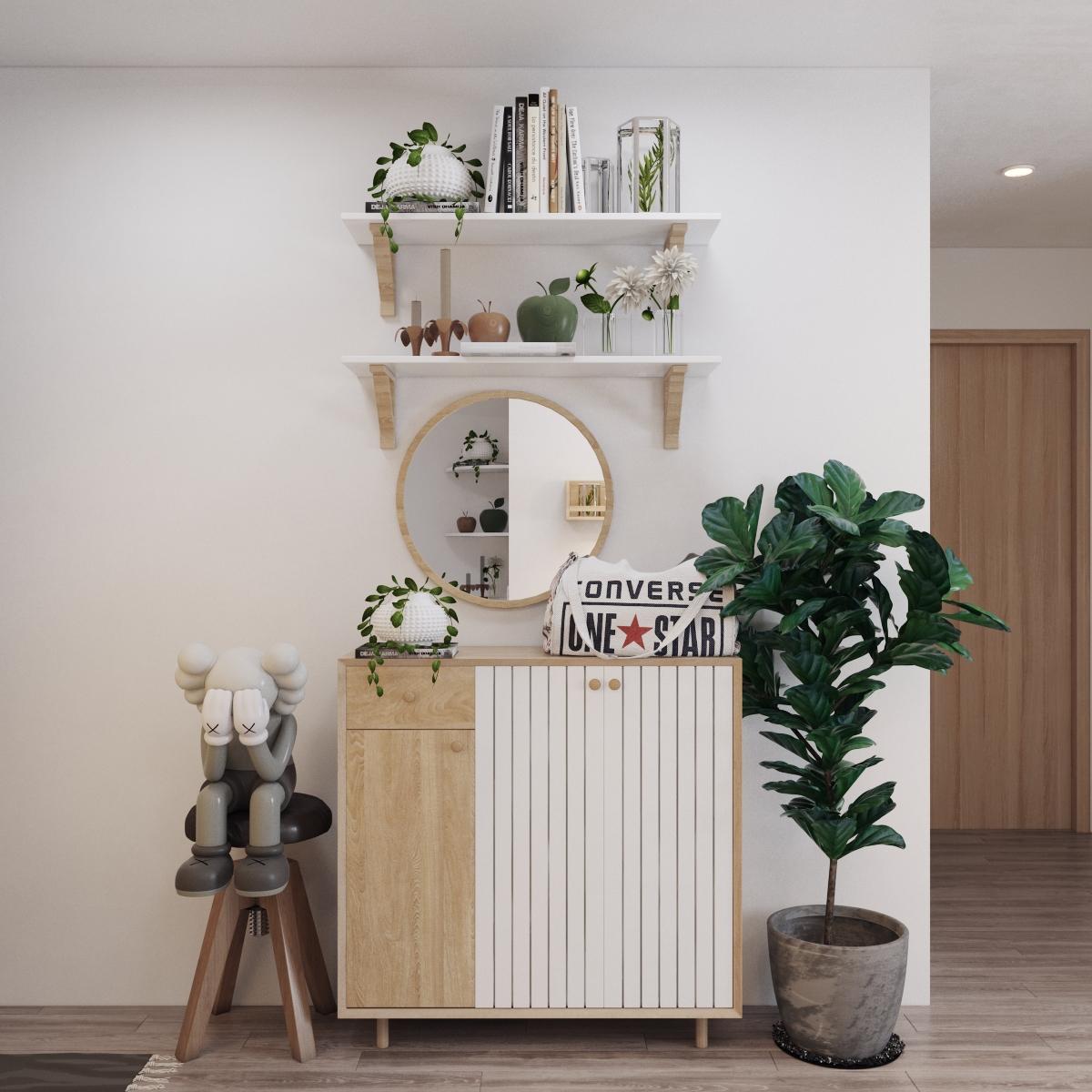 Ngay từ khu vực lối v&agrave;o, căn hộ 70m2 đ&atilde; g&acirc;y được thiện cảm với tủ gi&agrave;y gọn xinh, gương tr&ograve;n mềm mại, chậu c&acirc;y xanh m&aacute;t... tạo cảm gi&aacute;c an y&ecirc;n đến lạ.