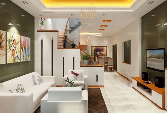 Ph&ograve;ng kh&aacute;ch nh&agrave; ống được b&agrave;i tr&iacute; tối giản với nội thất m&agrave;u trắng chủ đạo. V&aacute;ch ngăn cầu thang tinh tế như một điểm nhấn trang tr&iacute;.