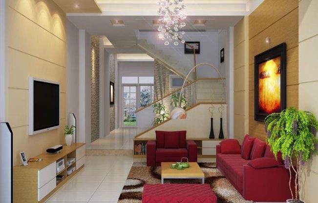 Phòng khách nhà ống hiện đại Điểm nhấn hút mắt của phòng khách là bộ ghế sofa màu đỏ đô sang trọng. Cầu thang với lan can kính cường lực trong suốt tạo độ thoáng cho không gian nhà ống.