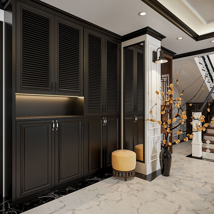 Lối vào căn hộ Duplex sang trọng với sàn lát gạch đá cẩm thạch và hệ tủ giày kịch trần tông màu đen huyền bí.