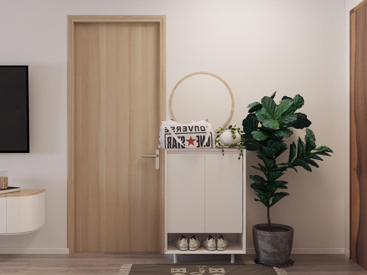 Lối v&agrave;o căn hộ 76m2 được decor theo phong c&aacute;ch hiện đại tối giản với tủ gi&agrave;y gọn xinh, chậu c&acirc;y xanh tươi tốt tạo cảm gi&aacute;c th&acirc;n thiện, ch&agrave;o đ&oacute;n.
