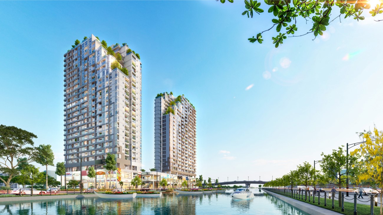 A couple of tall buildings by a body of waterDescription automatically generated with low confidence