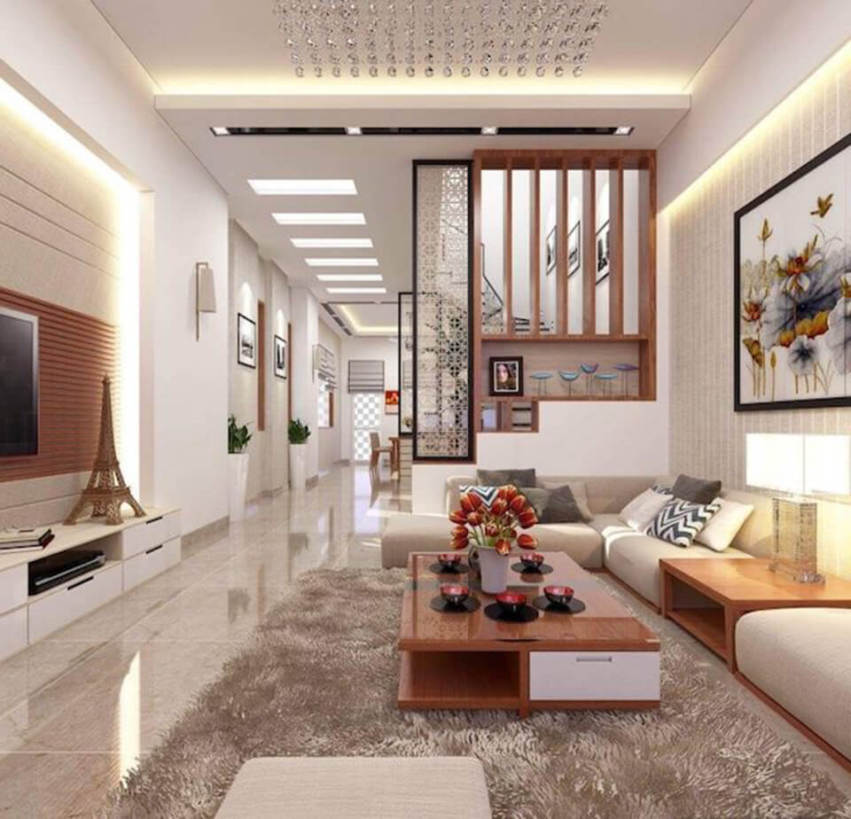 Ph&ograve;ng kh&aacute;ch phong c&aacute;ch hiện đại đơn giản với bảng m&agrave;u trung t&iacute;nh sang trọng. V&aacute;ch ngăn gỗ tho&aacute;ng che chắn khu vực cầu thang nh&agrave; ống.