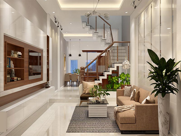 Không gian phòng khách nhà ống 47m2 thoáng sáng với đủ đầy tiện nghi hiện đại. Thiết kế sàn giật cấp phân tách với phòng ăn và bếp nấu phía trong.