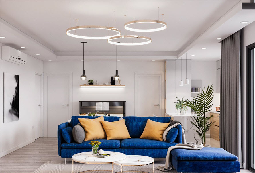 Bộ ghế sofa m&agrave;u xanh coban v&agrave; những chiếc gối tựa m&agrave;u v&agrave;ng nắng khiến ph&ograve;ng kh&aacute;ch căn hộ như bừng s&aacute;ng v&agrave; tr&agrave;n đầy sức sống.