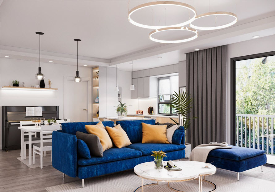Ph&ograve;ng kh&aacute;ch - bếp - ph&ograve;ng ăn li&ecirc;n th&ocirc;ng rộng r&atilde;i, tho&aacute;ng s&aacute;ng. Sofa m&agrave;u xanh coban trở th&agrave;nh điểm nhấn trẻ trung v&agrave; cực h&uacute;t mắt.