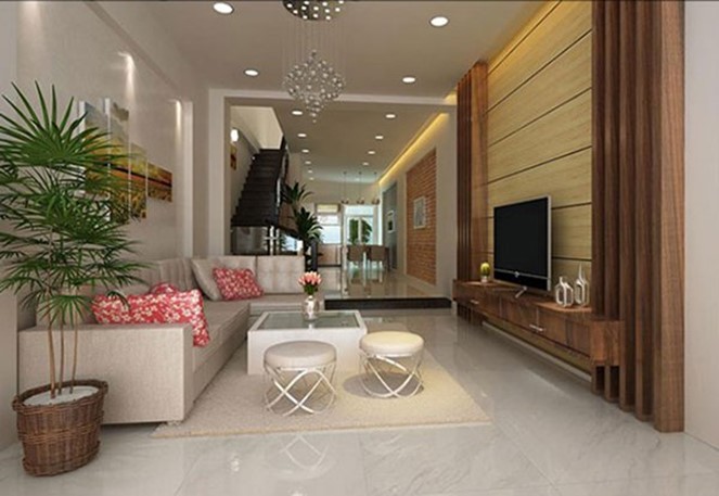 Kh&ocirc;ng gian ph&ograve;ng kh&aacute;ch hiện đại tối giản với bộ ghế sofa t&ocirc;ng m&agrave;u trung t&iacute;nh sang trọng. Tranh tường v&agrave; chậu c&acirc;y xanh tốt tạo điểm nhấn sinh động cho căn ph&ograve;ng.