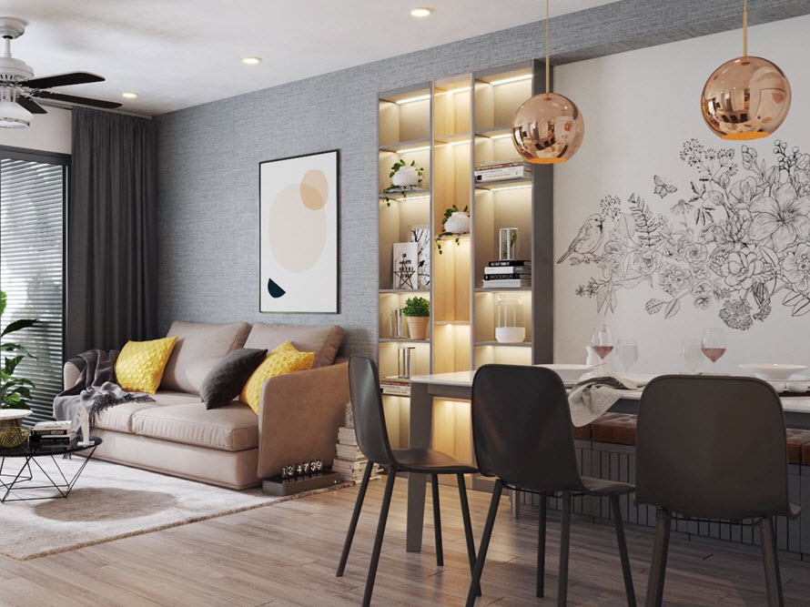 Kệ trang trí âm tường phân chia tương đối giữa phòng khách và phòng ăn. Đèn LED tông màu vàng tạo cảm giác ấm cúng, gần gũi.