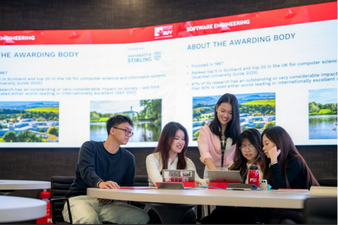 A group of people sitting at a table looking at a tablet  AI-generated content may be incorrect.