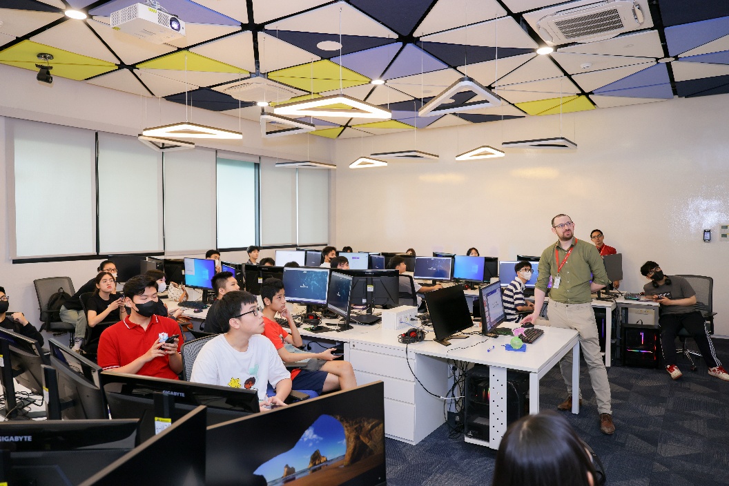 A group of people in a room with computers  AI-generated content may be incorrect.