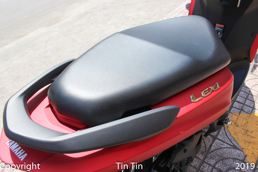 Phần y&ecirc;n xe của Yamaha Lexi 125 thiết kế liền lạc, y&ecirc;n l&aacute;i v&agrave; y&ecirc;n phụ ngăn c&aacute;ch với nhau bằng một gờ nhỏ. Tay nắm xe dạng to bản được sơn m&agrave;u đen nh&aacute;m.