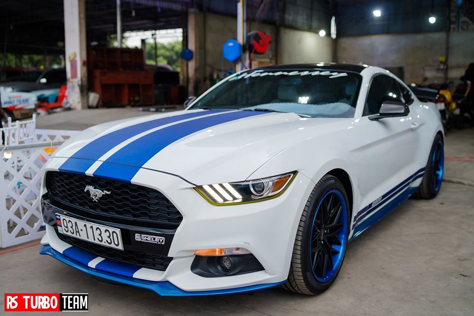 Một chiếc Ford Mustang thế hệ thứ 6 của đội B&igrave;nh Phước c&oacute; ngoại thất trắng kết hợp m&agrave;u xanh dương.