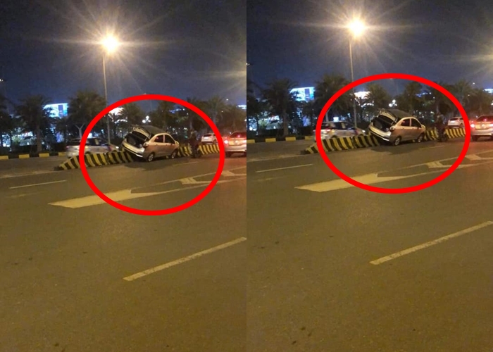 Một chiếc &ocirc; t&ocirc; cũng leo dải ph&acirc;n c&aacute;ch v&agrave; bị mắc kẹt tại nh&agrave; ga T1 s&acirc;n bay Nội B&agrave;i