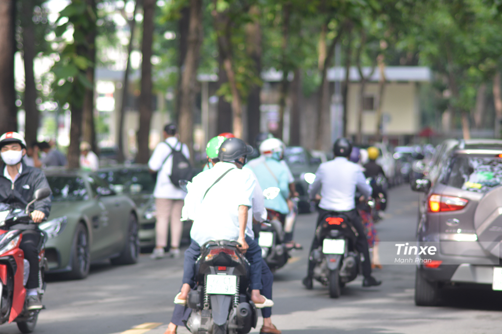 Một số người điều khiển xe máy còn chủ động giảm tốc độ để nhìn ngắm dàn siêu xe của Chủ tịch Trung Nguyên đỗ bên đường.