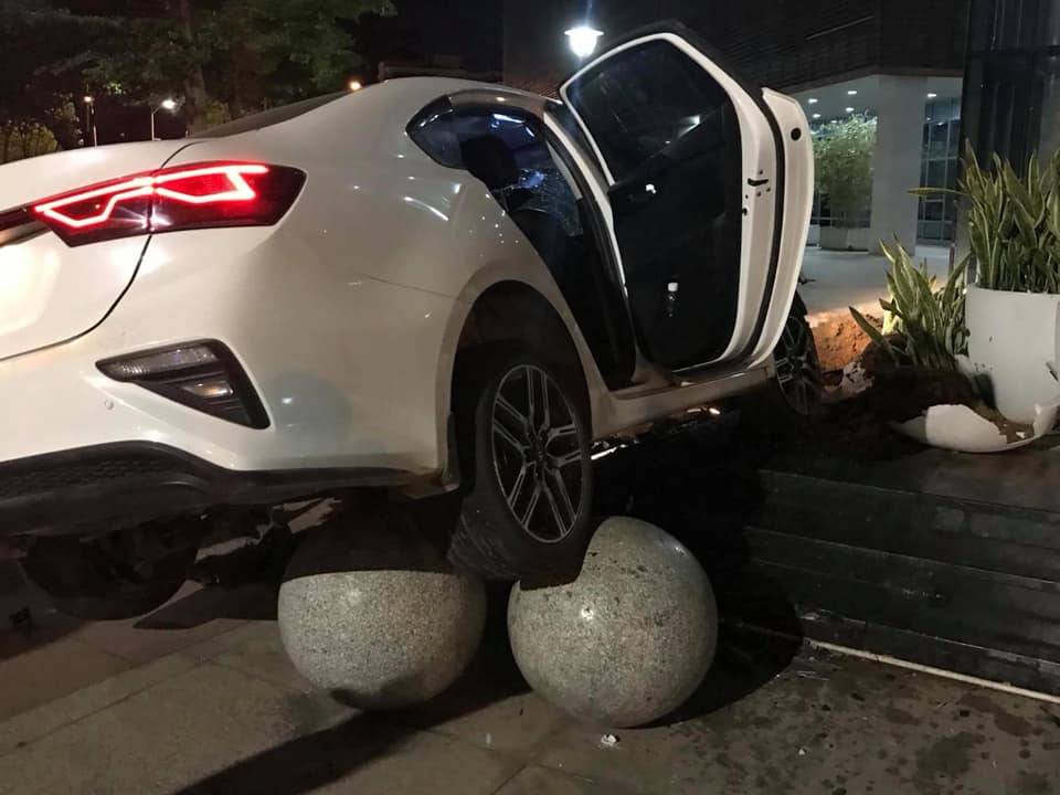 Chiếc Kia Cerato tông vào những hòn đá trang trí bên ngoài tòa nhà