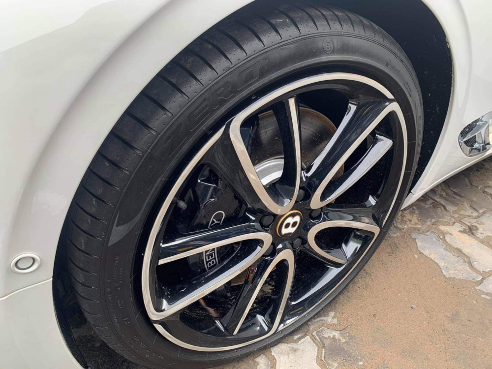 Xe sở hữu m&acirc;m 5 chấu k&eacute;p sơn 2 t&ocirc;ng m&agrave;u tương phản l&agrave; viền logo chữ B l&agrave; m&agrave;u v&agrave;ng thể hiện xe thuộc phi&ecirc;n bản 100 năm kỷ niệm sinh nhật h&atilde;ng Bentley v&agrave;o năm ngo&aacute;i