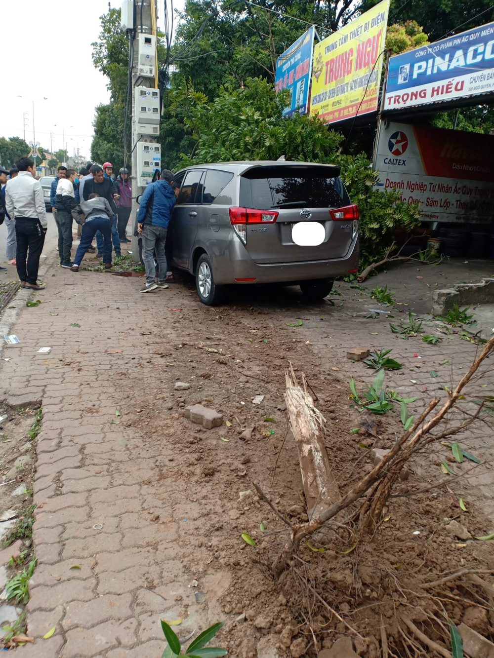 Hiện trường xe Toyota Innova lao lên vỉa hè, húc gãy cây xanh và chỉ chịu dừng lại khi tông vào trụ điện