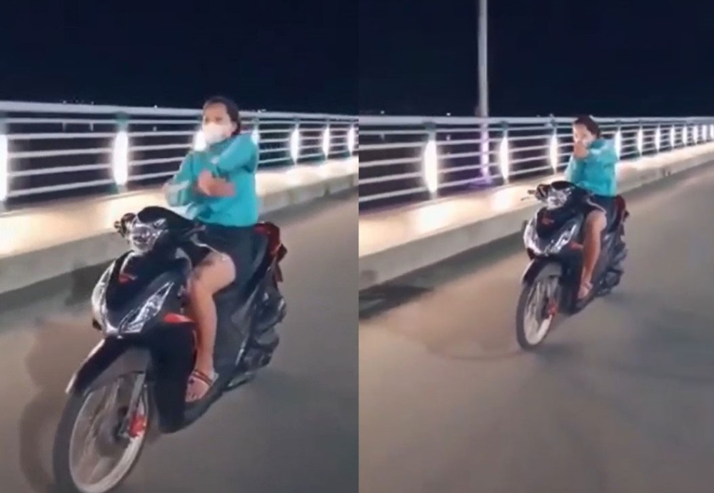 Cô gái thả hai tay để múa quạt và bắn tim trên cầu Thạch Bích