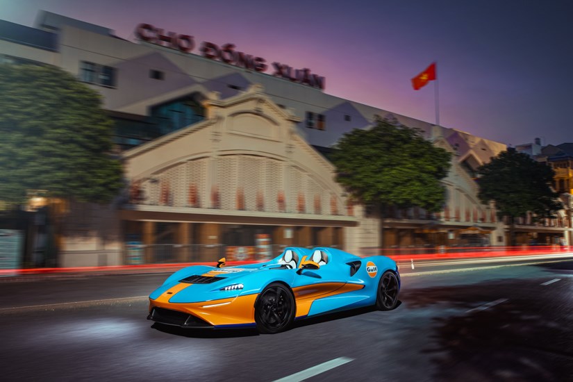 H&igrave;nh ảnh xe McLaren Elva v&agrave; ph&iacute;a sau l&agrave; ng&ocirc;i chợ Đồng Xu&acirc;n