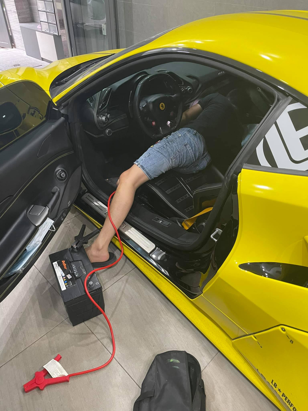 Thợ đang thay bình ắc-quy mới cho xe Ferrari 488 GTB