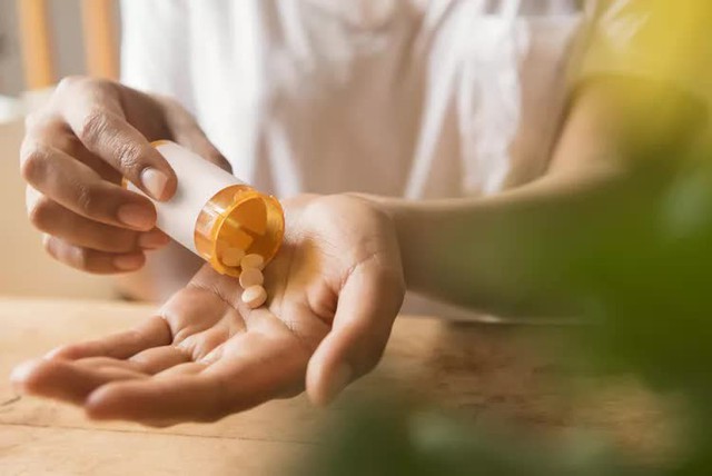 hands-of-african-american-woman-holding-prescription-medicine-916194256-5c12c13e4cedfd0001102a68-17612363842501740622190.jpg
